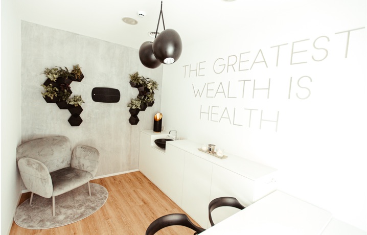 The Reset Studio lounge with the wall lettering "The greatest wealth is health"